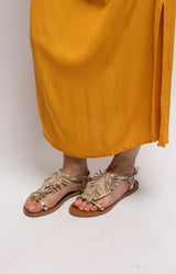 Beige and gold flat sandals with statement fringe detailing, metallic straps and an adjustable ankle strap – Volange Paris, Parisian fashion in Sydney (Mosman, Paddington and Bronte) or Australia-wide online.