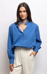 Cornflower blue blouse in 100% cotton with an elegant stand-up collar, button-down front and relaxed fit – Volange Paris, Parisian fashion in Sydney (Mosman, Paddington and Bronte) or Australia-wide online.