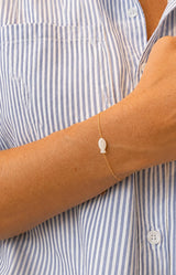 Delicate gold-tone bracelet with a mother-of-pearl fish charm and fine adjustable chain, water-resistant and non-tarnish – Volange Paris, Parisian fashion in Sydney (Mosman, Paddington and Bronte) or Australia-wide online.