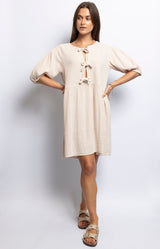 Beige cotton gauze dress with tie-front detail and puff sleeves – Wardrobe essential French fashion by Volange Paris.
