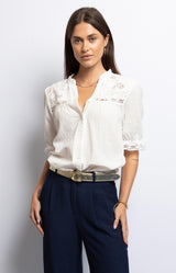 Elegant white cotton blouse with delicate lace panels, puffed sleeves, and scalloped neckline – French style by Volange Paris.