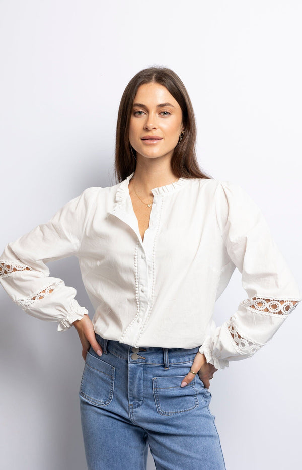 White cotton blouse with lace inserts, covered-button placket, and ruffle cuffs – French style by Volange Paris.