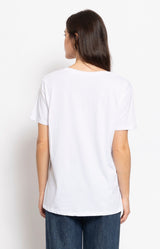 White cotton graphic T-shirt featuring a sparkling Champagne S'il Vous Plaît slogan, relaxed fit and flattering V-neckline for effortless Parisian style – Volange Paris, Parisian fashion in Sydney (Mosman, Paddington and Bronte) or Australia-wide online.