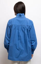 Cornflower blue blouse in 100% cotton with an elegant stand-up collar, button-down front and relaxed fit – Volange Paris, Parisian fashion in Sydney (Mosman, Paddington and Bronte) or Australia-wide online.