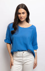 Cornflower blue linen cotton top with a relaxed oversized fit, soft boat neckline and rolled sleeves for effortless everyday style – Volange Paris, Parisian fashion in Sydney (Mosman, Paddington and Bronte) or Australia-wide online.
