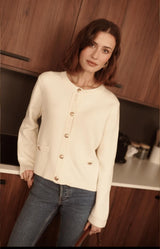 Cream knit cardigan with gold embossed buttons and front pockets – Volange Paris, Parisian fashion in Sydney (Mosman, Paddington and Bronte) or Australia-wide online.