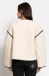 Soft cream teddy jacket with a relaxed silhouette, button-front closure and cosy textured finish for effortless winter layering – Volange Paris, Parisian fashion in Sydney (Mosman, Paddington and Bronte) or Australia-wide online.
