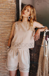 Beige embellished linen-blend top with metallic stud detailing and a relaxed fit — chic summer style from Volange Paris.