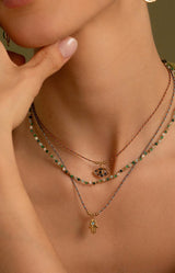Gold eye pendant necklace on multicoloured cord with zirconium stones Parisian-inspired jewellery by Volange Paris.