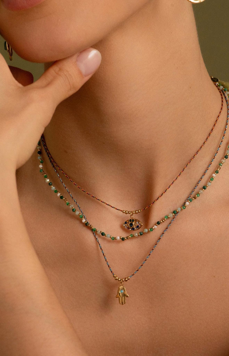 Gold eye pendant necklace on multicoloured cord with zirconium stones Parisian-inspired jewellery by Volange Paris.