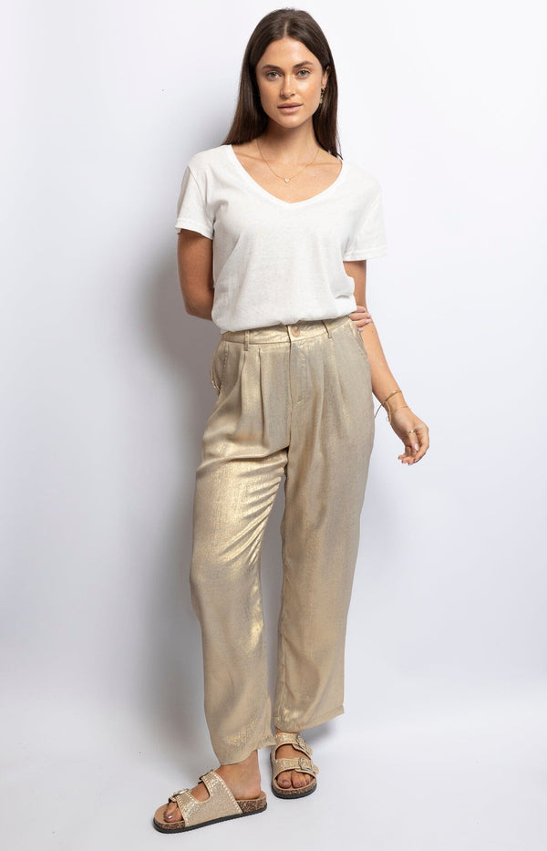 Shimmering gold polyester tapered pants with pleated front, elastic waist, and button closure – Luxe Parisian sparkle by Volange Paris.