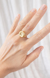 Gold ring with round medallion and delicate starburst motif, Parisian elegance by Volange Paris, French fashion in Sydney