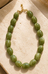 Green bead statement necklace with glossy olive resin beads and gold-tone details – Parisian jewellery by Volange Paris, available in Sydney (Mosman, Paddington and Bronte) or Australia-wide online.