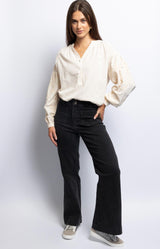 High-waisted wide-leg black jeans with front patch pockets and double-button closure – Volange Paris, French fashion.
