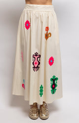 Ivory cotton maxi skirt with colourful embroidered motifs, a fitted front waistband and relaxed flowing shape – Volange Paris, Parisian fashion in Sydney (Mosman, Paddington and Bronte) or Australia-wide online.