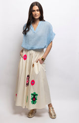 Ivory cotton maxi skirt with colourful embroidered motifs, a fitted front waistband and relaxed flowing shape – Volange Paris, Parisian fashion in Sydney (Mosman, Paddington and Bronte) or Australia-wide online.