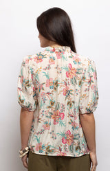 Ivory floral blouse with a colourful print, ruffled neckline, neck ties and puff sleeves – Volange Paris, Parisian fashion in Sydney (Mosman, Paddington and Bronte) or Australia-wide online.