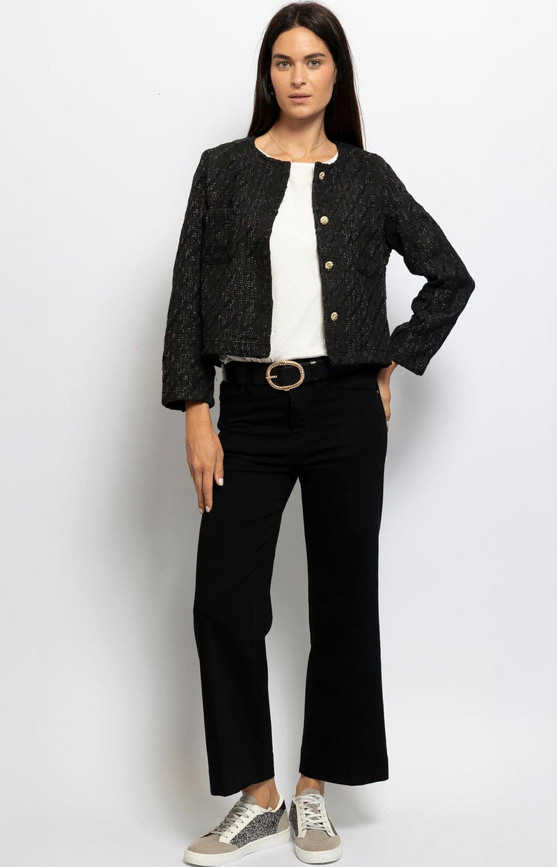 Black cropped jacket with subtle shimmer and gold buttons, timeless Parisian chic – French fashion from Volange Paris.