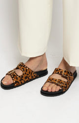 Leopard-print slides with double straps, gold buckles and stud details – Parisian elegance by Volange Paris.