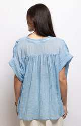 Light blue cotton blouse with a relaxed oversized fit, flattering V-neckline and airy cotton voile fabric – Volange Paris, Parisian fashion in Sydney (Mosman, Paddington and Bronte) or Australia-wide online.