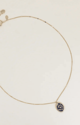 Midnight blue celestial pendant necklace with a golden stainless steel chain and sun, moon and star motif – Volange Paris, Parisian fashion in Sydney (Mosman, Paddington and Bronte) or Australia-wide online.