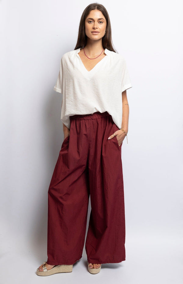 Flowy bordeaux wide-leg pants with frill elastic waistband, lightweight fabric for relaxed Parisian chic – Timeless French Fashion by Volange Paris.