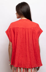 Red cotton voile blouse with a relaxed oversized fit, flattering V-neckline, loose sleeves and gathered shoulders. 100% cotton – Volange Paris, Parisian fashion in Sydney (Mosman, Paddington and Bronte) or Australia-wide online.