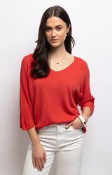 Red lightweight knit top with a flattering V-neck, batwing sleeves and relaxed draped fit in a soft modal blend – Volange Paris, Parisian fashion in Sydney (Mosman, Paddington and Bronte) or Australia-wide online.