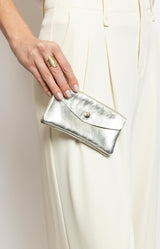 Shiny silver leather wallet with gold snap button and multiple compartments – Parisian elegance by Volange Paris.