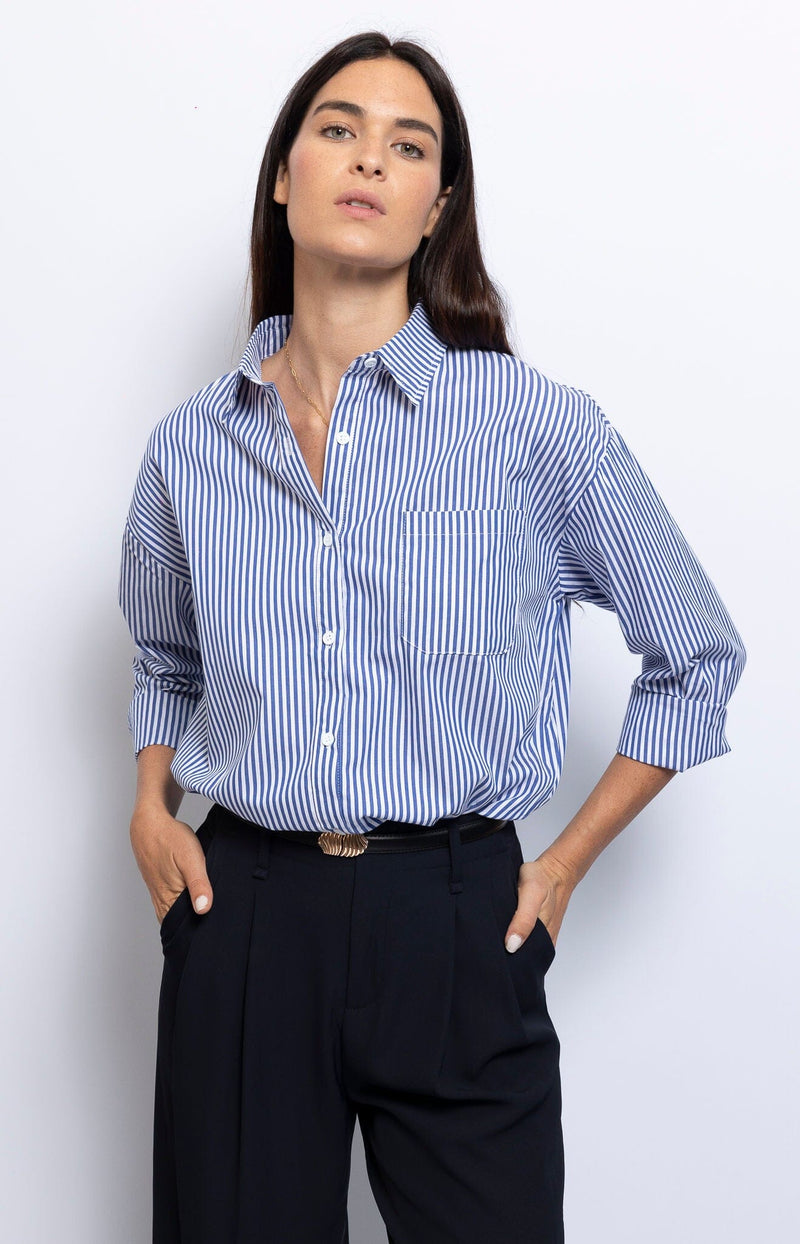 Blue and white striped shirt relaxed silhouette and chest pocket, effortless Parisian style – French fashion by Volange Paris.
