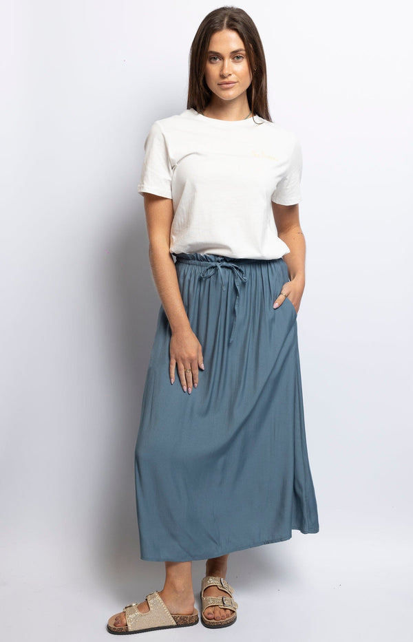 Flowy slate blue midi skirt with ruffled drawstring waist and pleated A-line design – Effortless Parisian breeziness by Volange Paris.