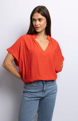 Red viscose blend top with V-neckline and relaxed draped fit – French fashion by Volange Paris.