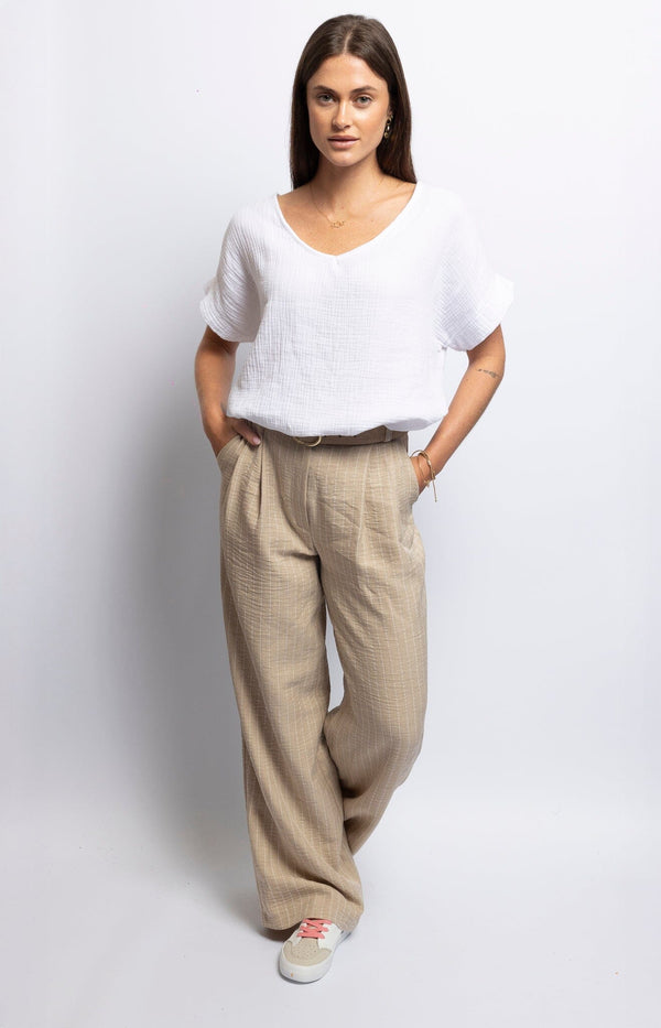 Beige wide-leg trousers with high waist, pockets, and relaxed fit – Effortless elegance Volange Paris Sydney.