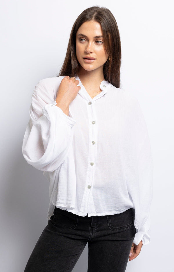 Chic white blouse crafted from lightweight cotton voile, featuring a V-neck and button detail – Parisian fashion by Volange Paris.
