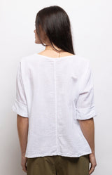 White linen cotton top with a relaxed oversized fit, soft boat neckline and rolled sleeves for effortless everyday style – Volange Paris, Parisian fashion in Sydney (Mosman, Paddington and Bronte) or Australia-wide online.
