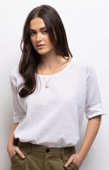 White linen cotton top with a relaxed oversized fit, soft boat neckline and rolled sleeves for effortless everyday style – Volange Paris, Parisian fashion in Sydney (Mosman, Paddington and Bronte) or Australia-wide online.
