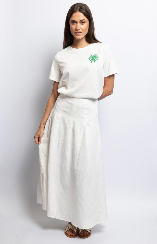 Airy white cotton maxi skirt with elastic high waist and subtle pleats for fluid movement – Timeless French summer flow by Volange Paris.