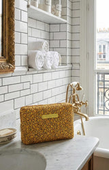 Block Print Yellow floral cotton toiletry bag with padded structure and zip closure – Parisian travel essential by Volange Paris.
